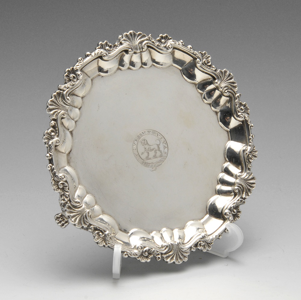 A late George III small silver salver, the circular form with shaped shell and scroll rim to a plain