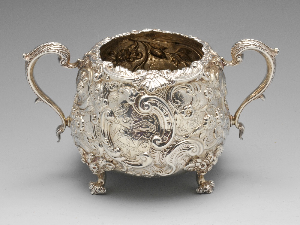 A late George III silver sugar bowl, the circular tapering form with twin foliate capped scroll