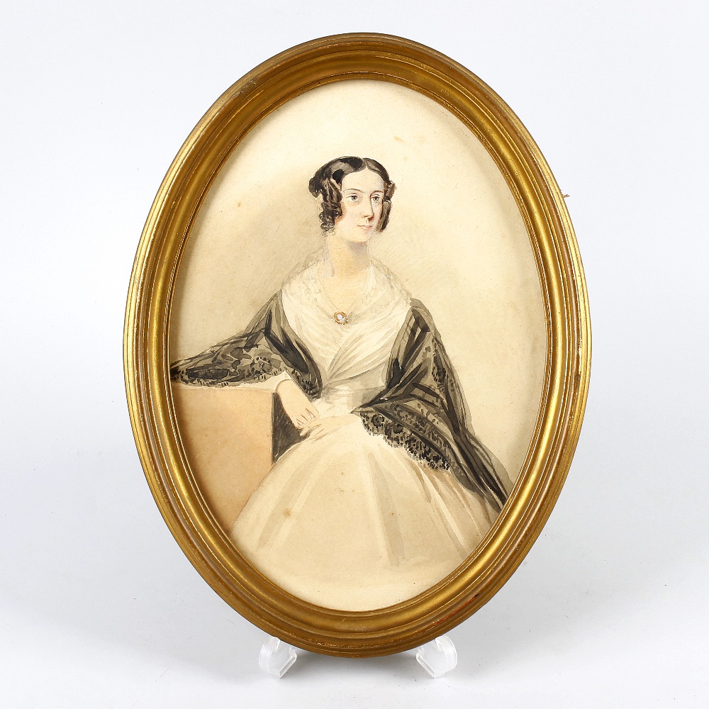 An early Victorian oval watercolour portrait of a lady.Depicted knee-length in three-quarter