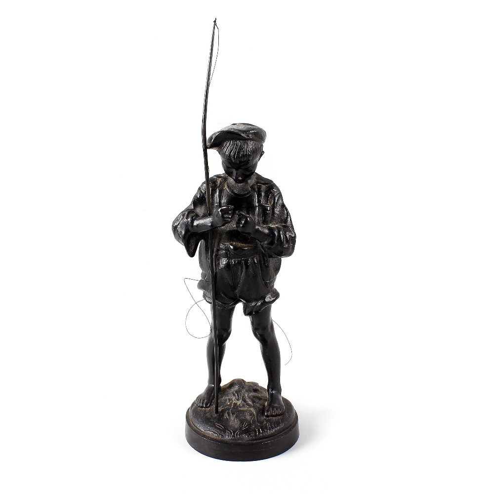 A 20th century Russian iron figure. Modelled as a young fisherboy dressed in rolled up shorts and