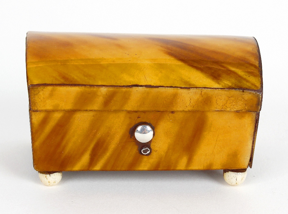 A small 19th century tortoiseshell trinket box. Modelled as a casket with hinged cover opening to