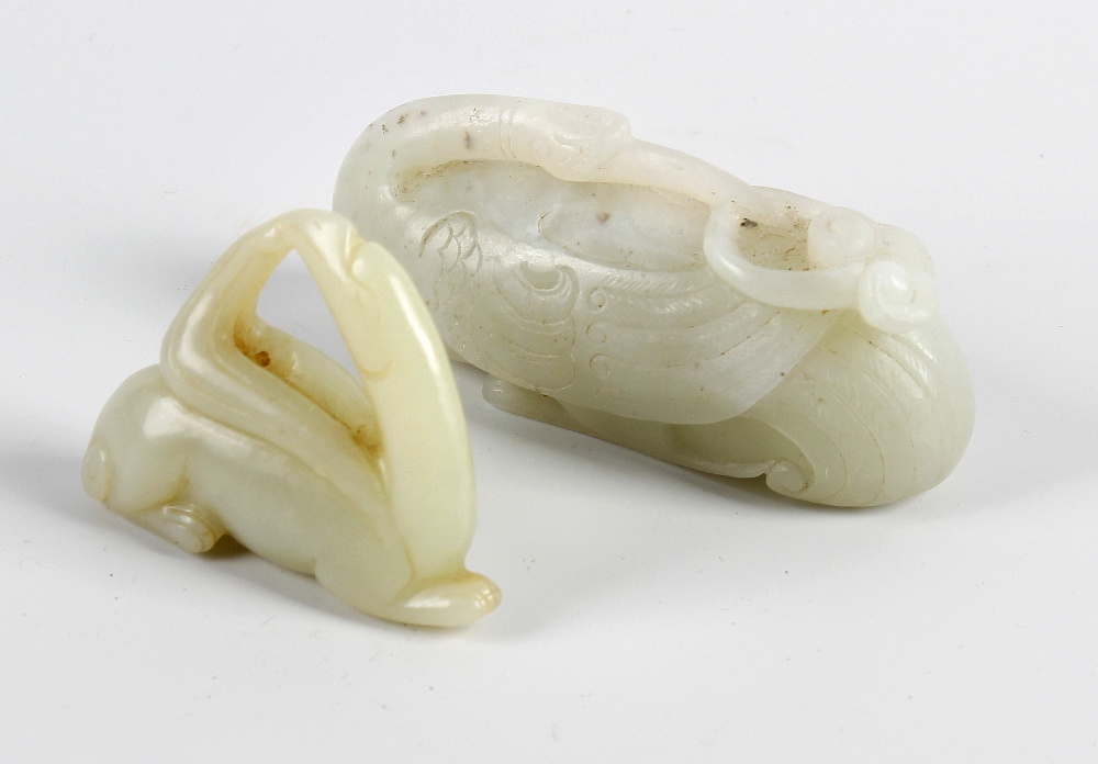 A nephrite Jade carved study of a crane, the head turned back and resting upon the body grasping a