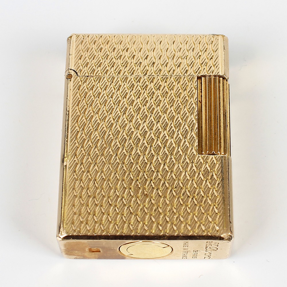 A Dupont gold-plated cigarette lighter. K3AJ87, of textured rectangular form, 1.75, (4.5cm) high.