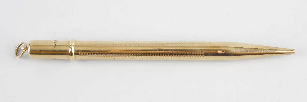 A 9ct gold mechanical pencil, of cylindrical form having textured decoration and rectangular