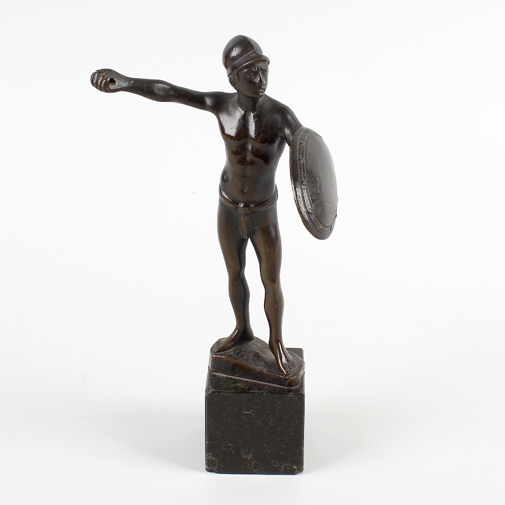 A 19th century Grand Tour souvenir bronze of a gladiator, modelled in a standing pose holding a