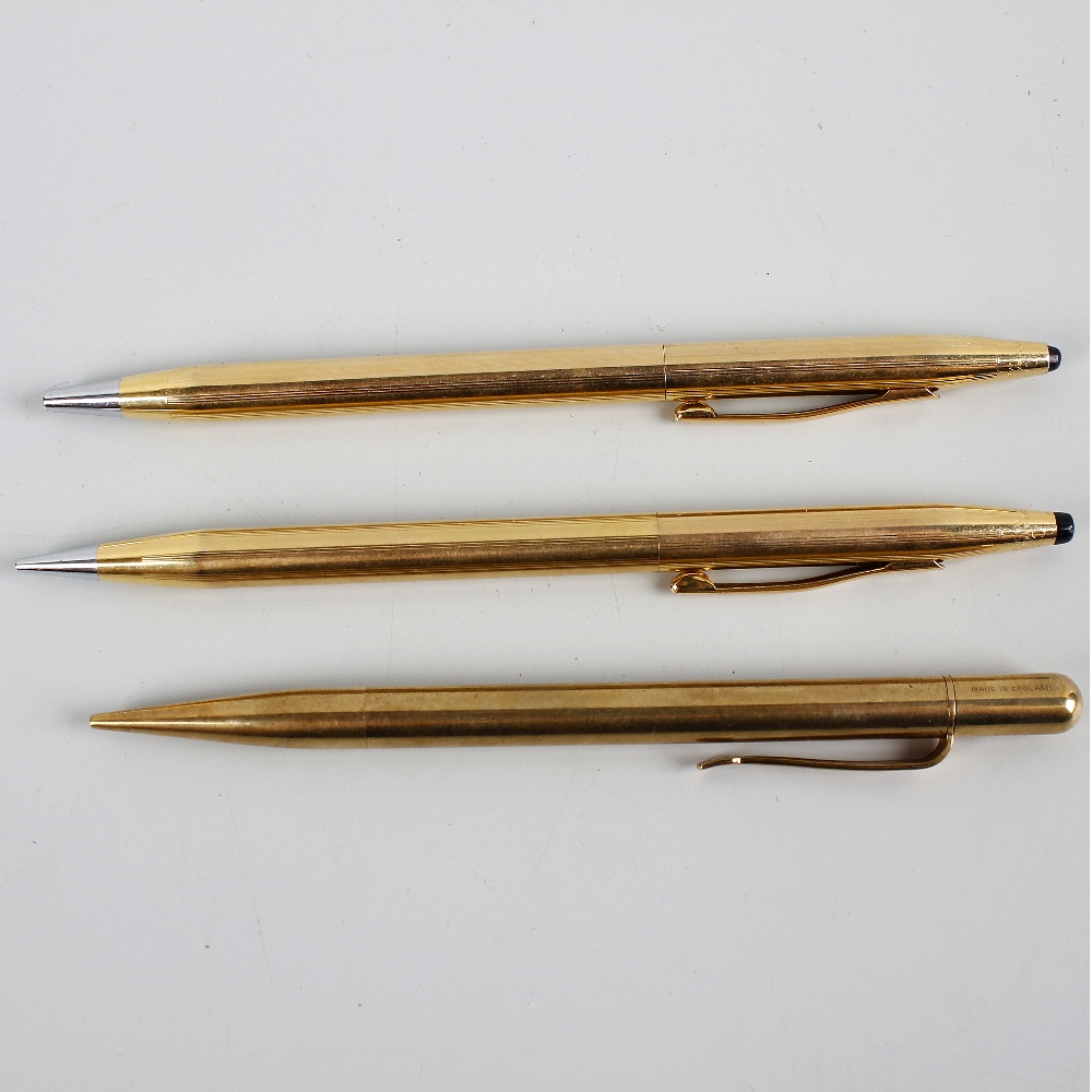 Three yellow metal mechanical pencils. Comprising a pair of Cross examples, each of similar tapering