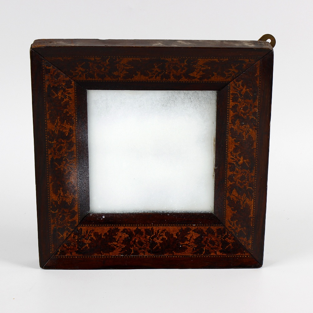 A Victorian Tunbridgeware inlaid wall mirror. The plain square mirror plate within canted surround