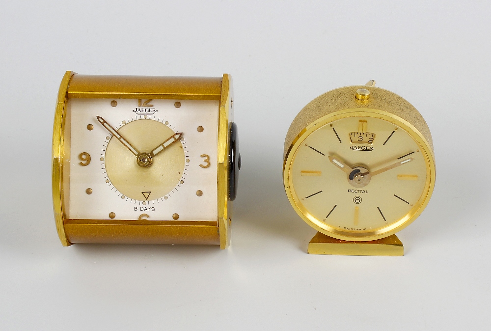 Two Jaeger travel clocks. The first with rectangular dial having gilt circular chapter with Arabic