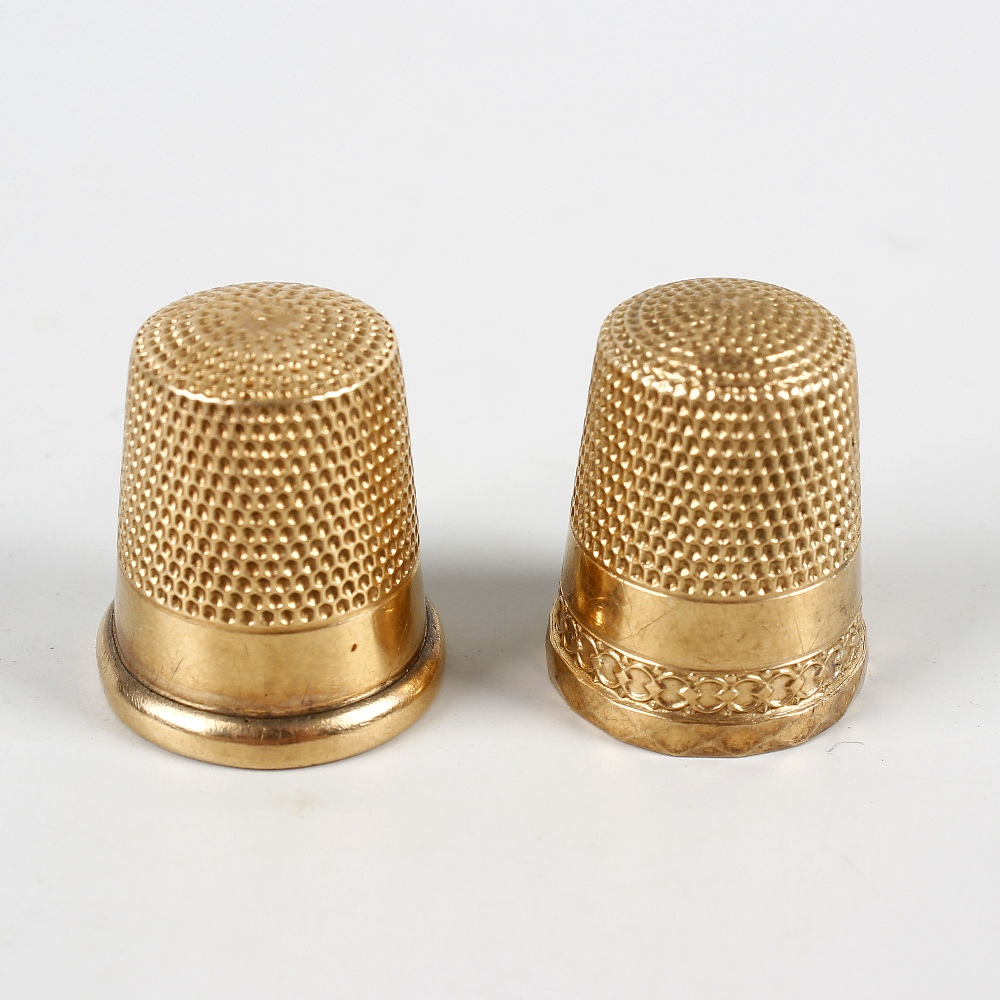 Two 10K yellow metal thimbles. One initialed CMS and numbered 9, the other initialed MG, both