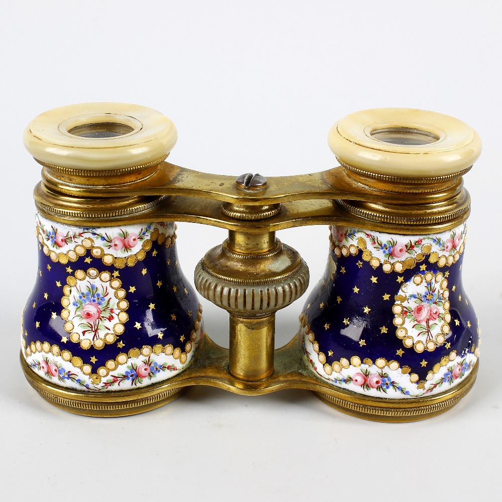 A good pair of French Palais Royal-type enamelled opera glasses. The mother of pearl eyepieces on