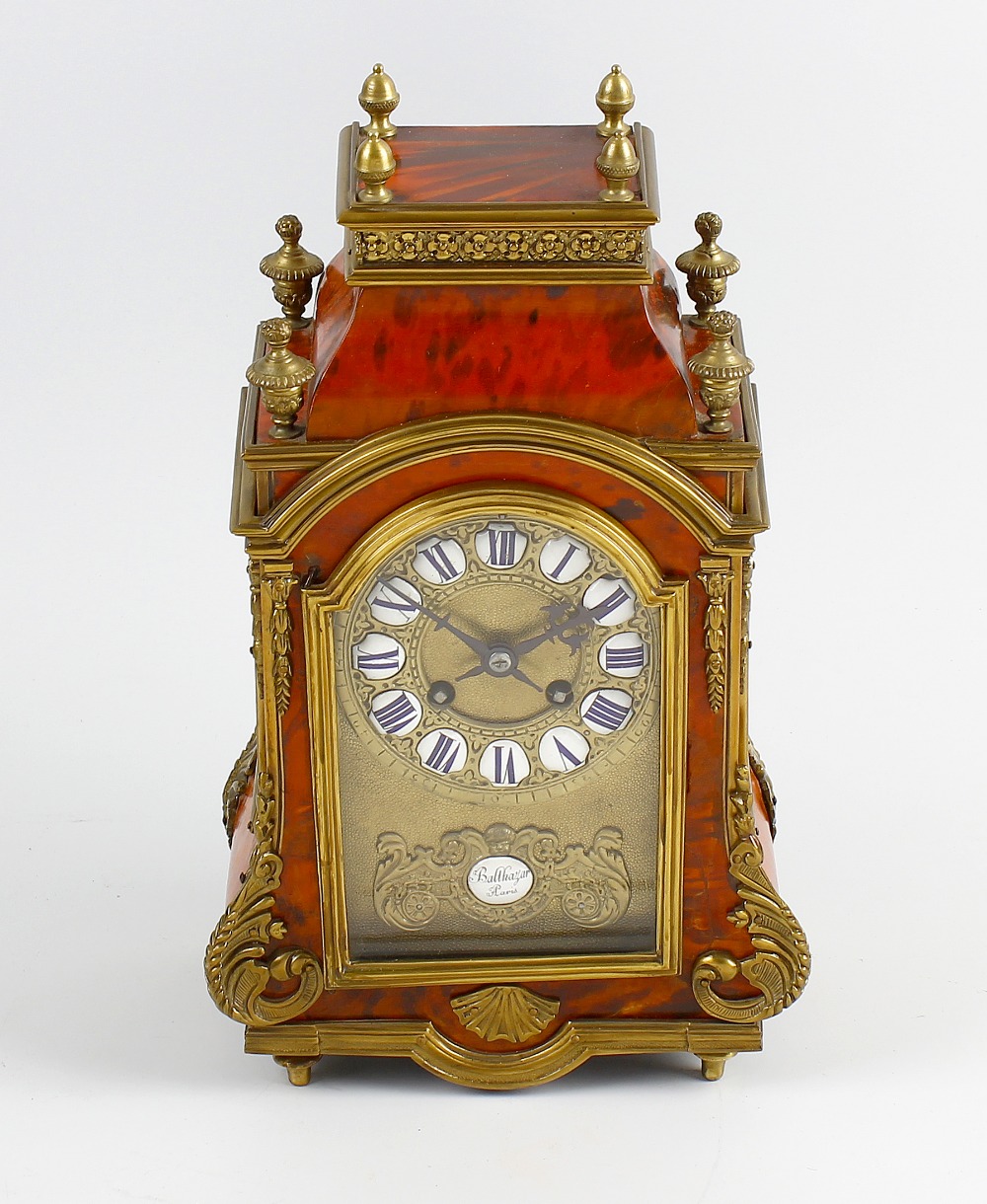 A good 19th century French red tortoiseshell mantel clock The break-arched brass dial with enamel