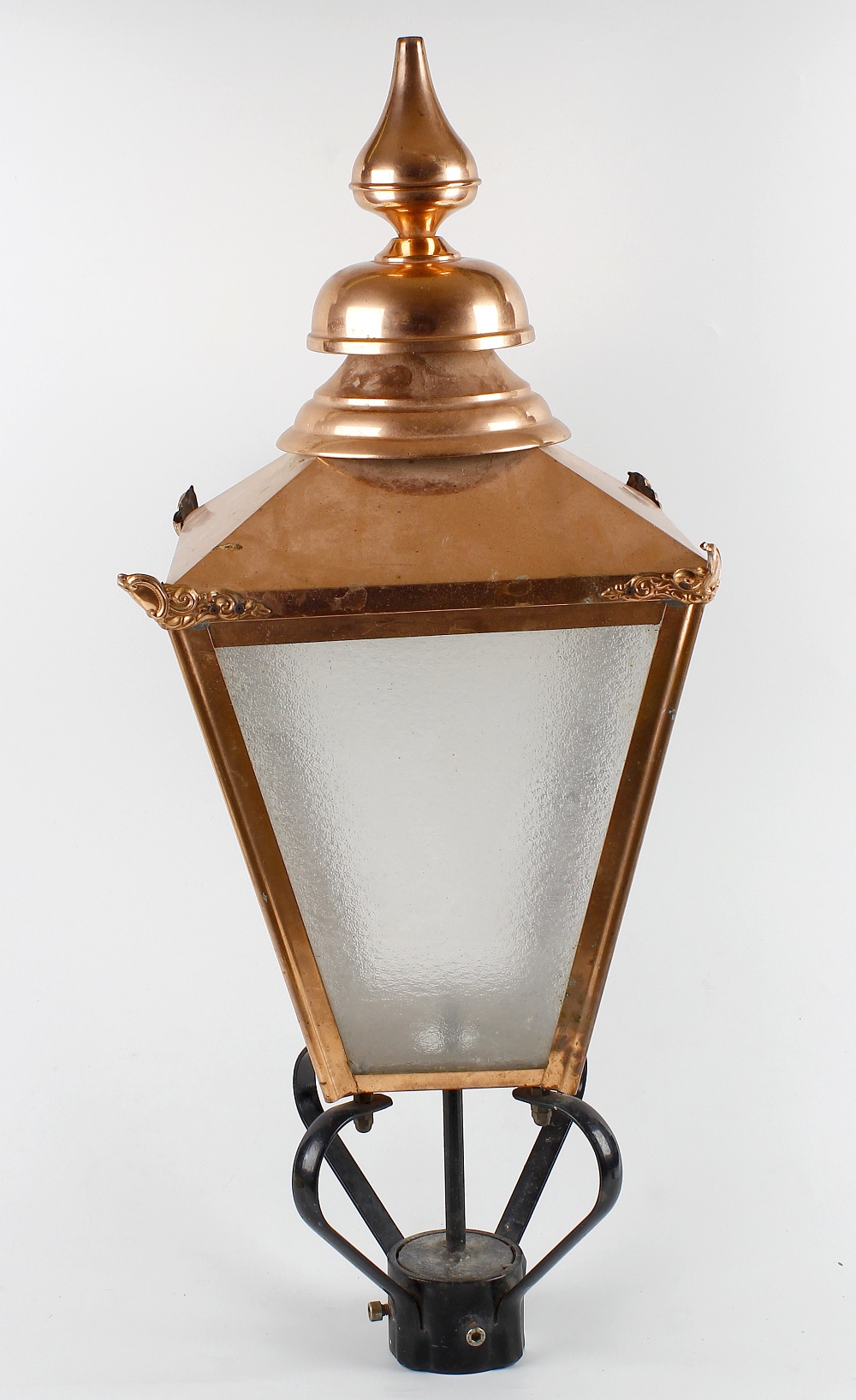 A reproduction copper lantern. The tiered spire finial over pyramidal top and tapering four sided