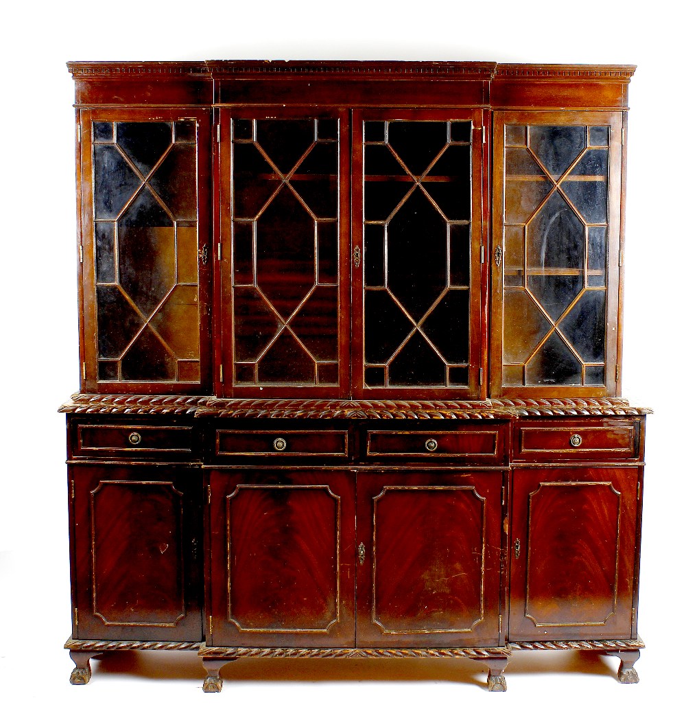 A mahogany reproduction breakfront bookcase cabinet The upper section with dentil cornice over two