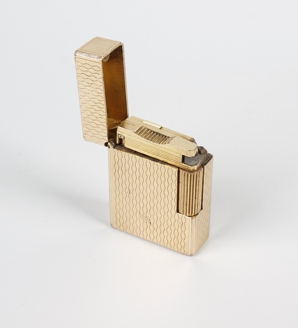 A Dupont gold-plated cigarette lighter. K3AJ87, of textured rectangular form, 1.75, (4.5cm) high. - Image 2 of 2