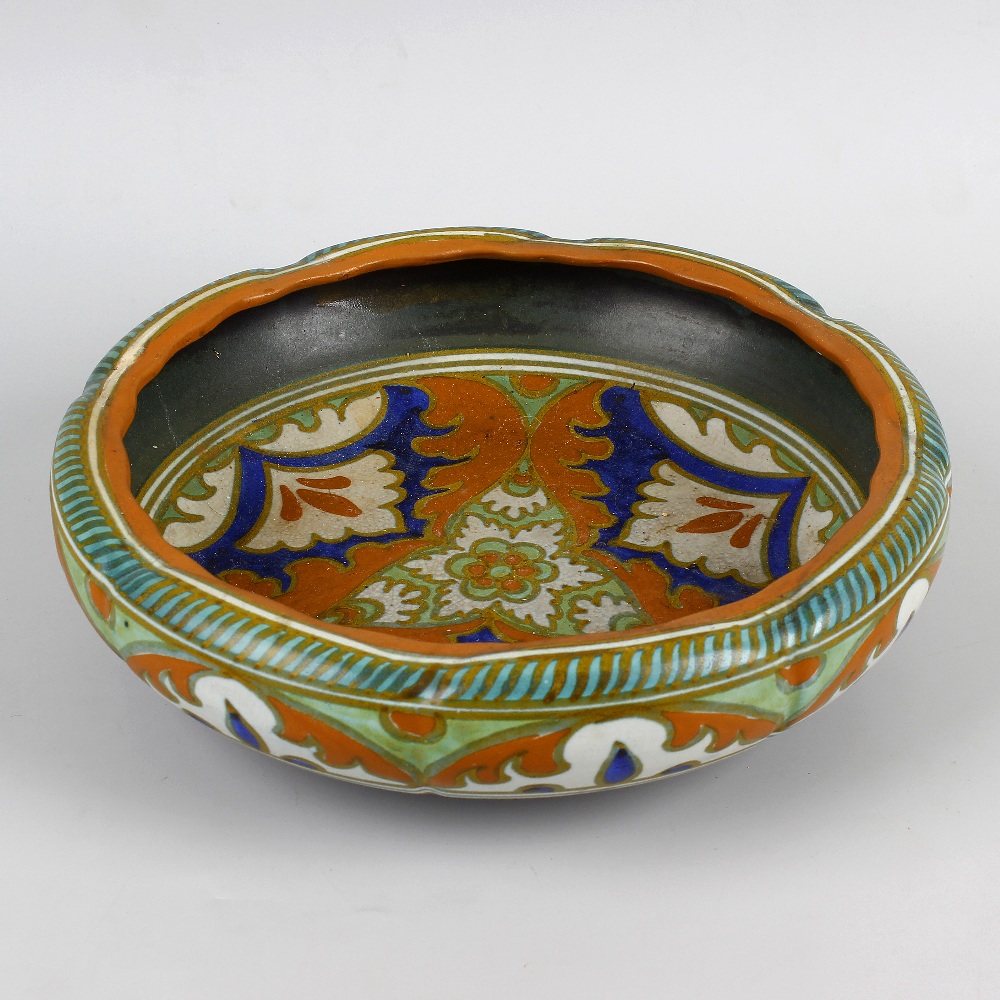 A Gouda pottery bowl. Of slightly lobed form decorated in orange, blue and cream glaze, the whole