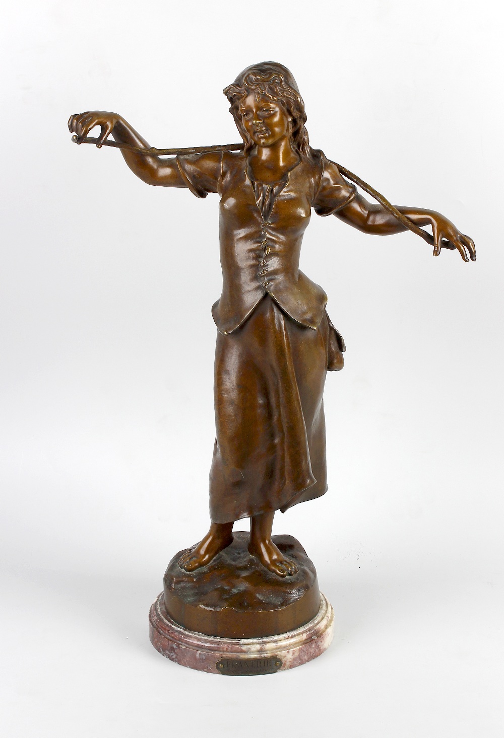 Marcel Debut, (1865-1933), A bronze figure 'Flanerie', modelled as a female figure with rustic