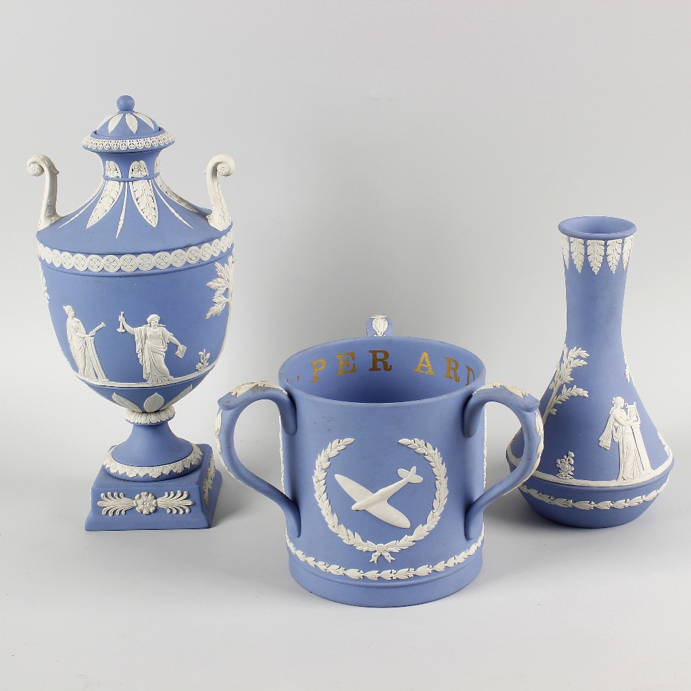 A box containing a Wedgwood blue jasperware twin handled pedestal vase and cover decorated with