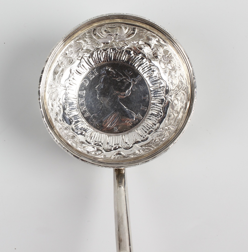 A baleen-handled white metal toddy ladle The repousse bowl inset with a Queen Anne 1708 coin, 13.75, - Image 2 of 2