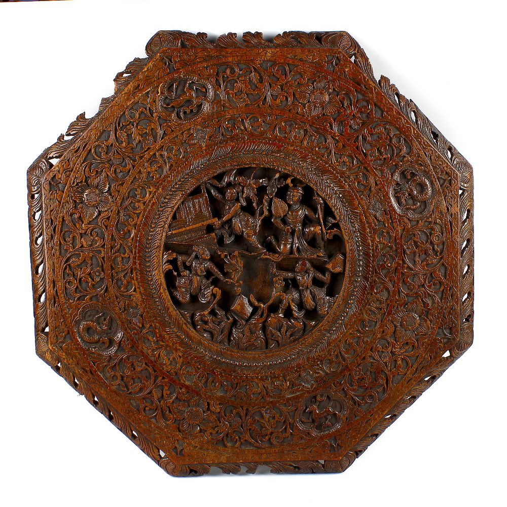 A 19th century Chinese carved wooden octagonal table top. The centre modelled in deep relief with