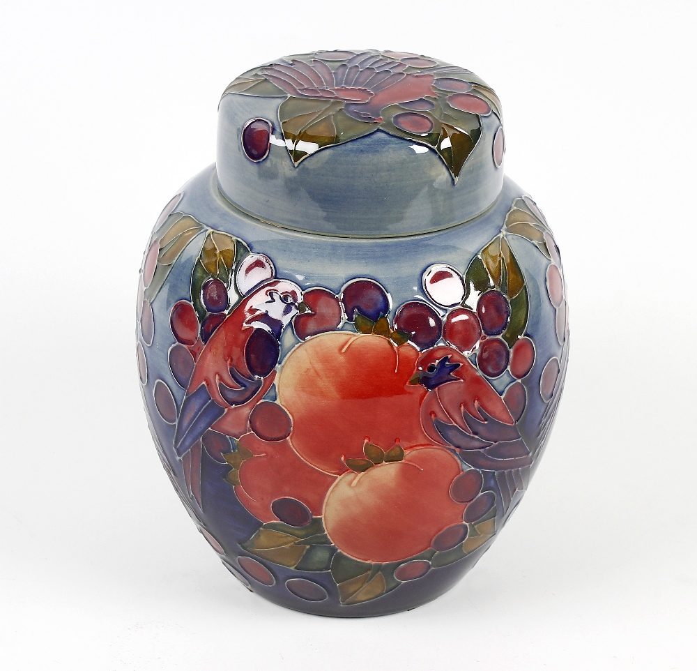 A Moorcroft pottery jar and cover, the ovoid body having blue/green glaze ground decorated with