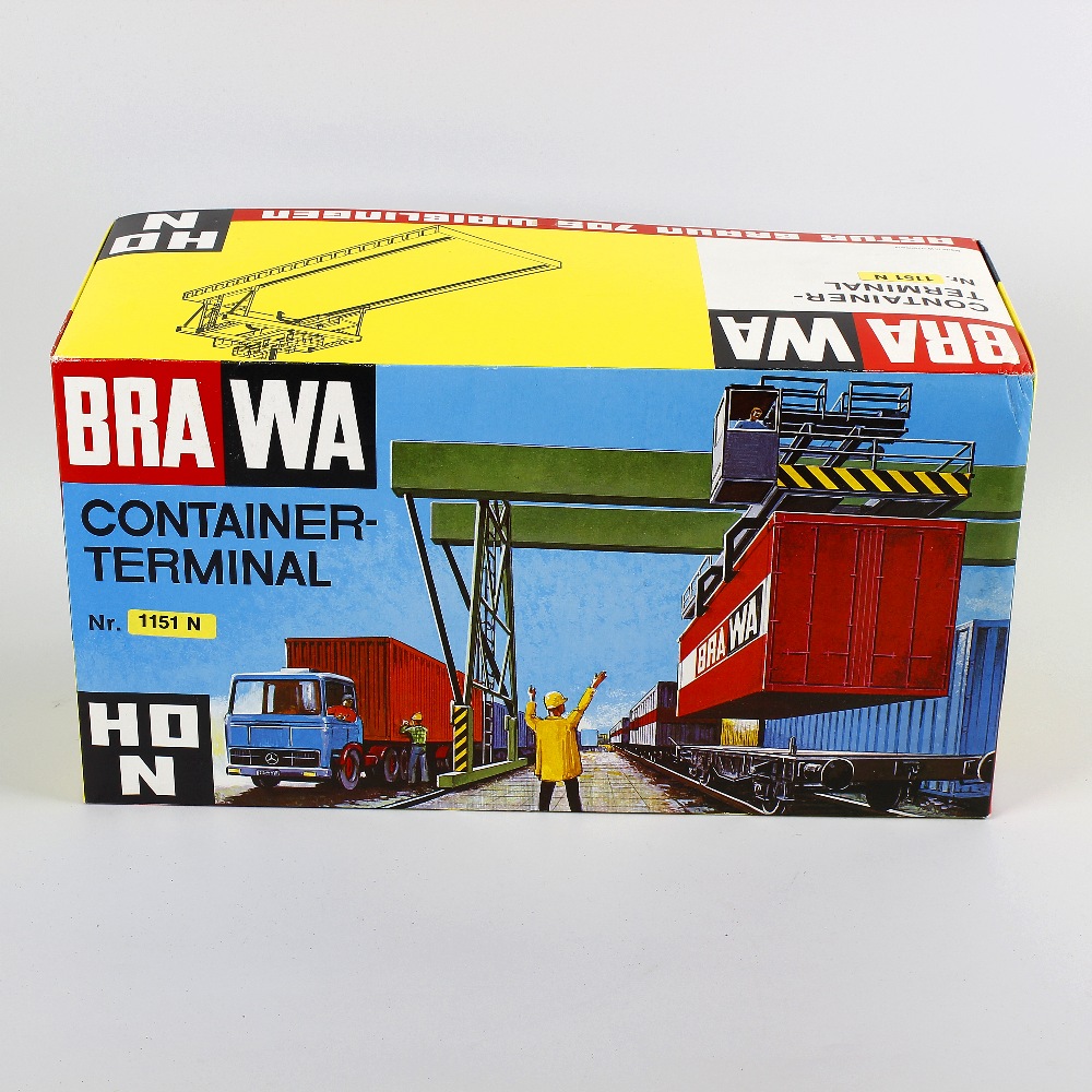 A box containing a mixed selection of Brawa, Pola and other H0/00 model railway plastic model