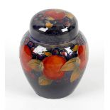 A William Moorcroft pottery Pomegranate and Berry pattern ginger jar Of ovoid form with domed