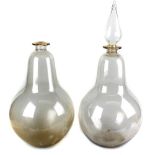 Two large blown glass apothecary or carboy display bottles, each of bulbous form, one with spire