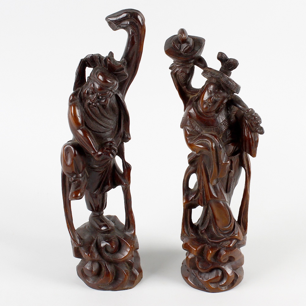 A pair of Oriental carved rootwood figures. One modelled as a muscular bearded figure with one