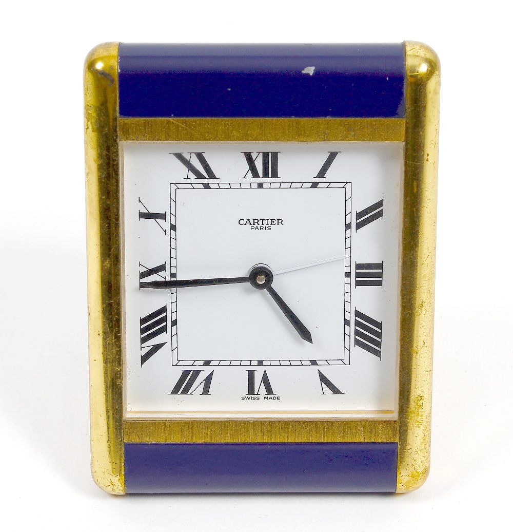 A Cartier desk clock The square white Roam dial marked CARTIER PARIS, within brass and dark blue