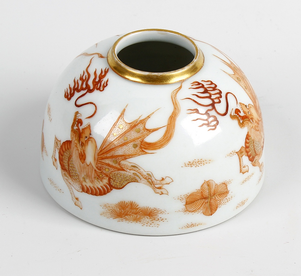 A Chinese porcelain brush pot or taibaizan. Of hemispherical form painted in burn orange with