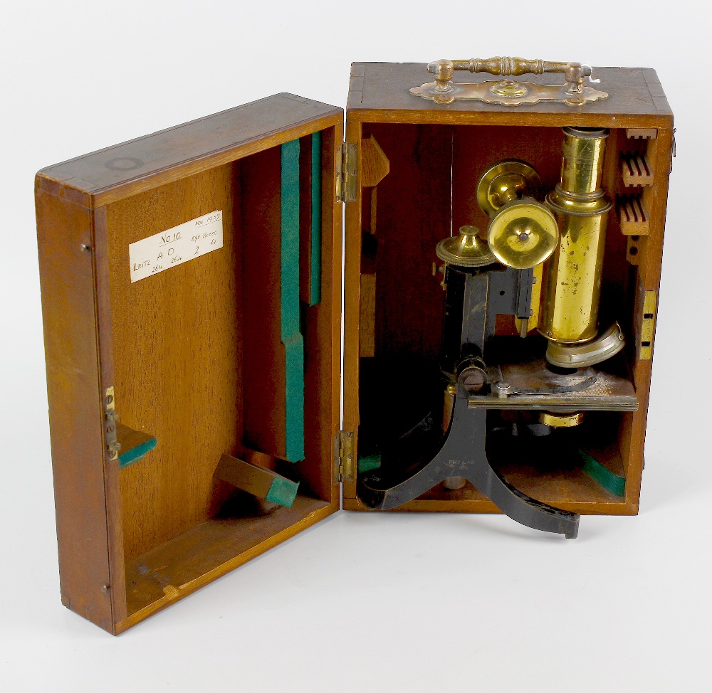 A students brass microscope. 8 (20.25) high fully extended, in hinged wooden box. Displaying heavy