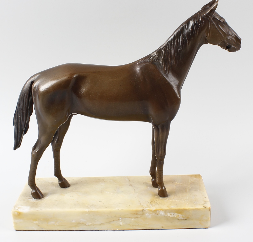 A bronze figure of a racehorse. Modelled wearing bridle and stood upon rectangular marble plinth, - Image 2 of 2