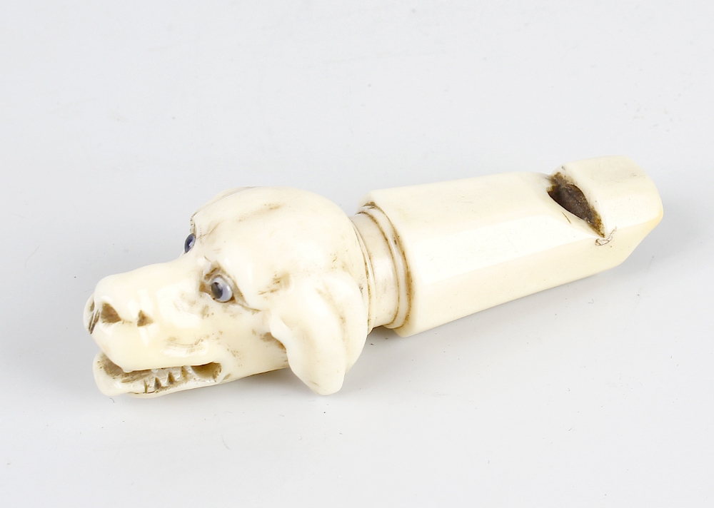 A Victorian ivory whistle, modelled as the head of a dog with open mouth and inset eyes, 3.1, (