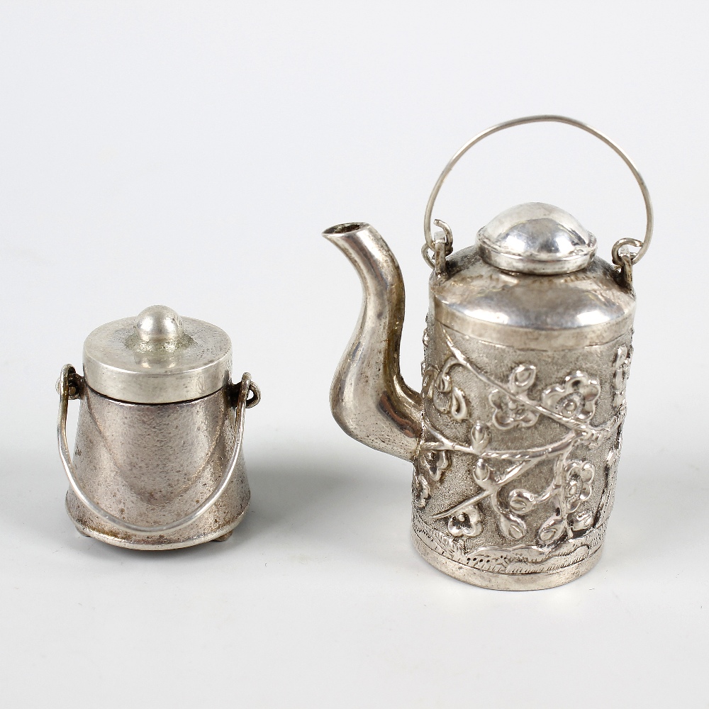 Two Chinese trade silver or white metal miniature items. Comprising: a cylindrical teapot with