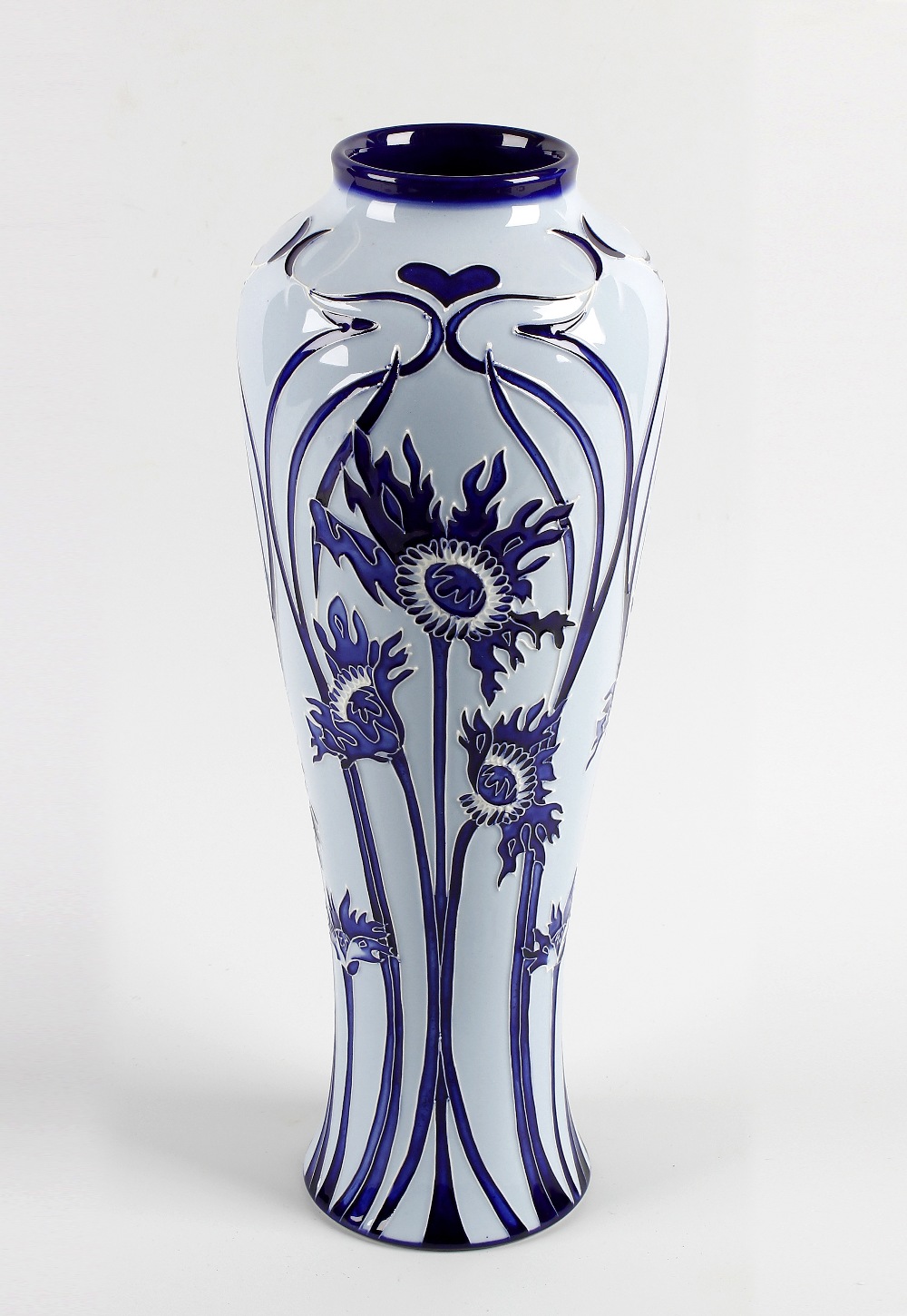 A modern Moorcroft pottery vase. Of slender baluster form decorated to the whole with Florian-