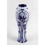 A modern Moorcroft pottery vase. Of slender baluster form decorated to the whole with Florian-