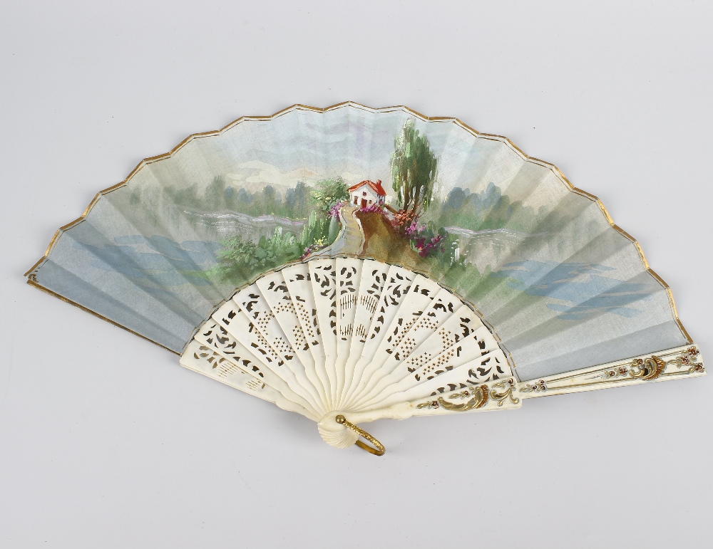 An early 20th century painted silk fan. Decorated with figures playing bowls before onlookers in a - Image 2 of 2