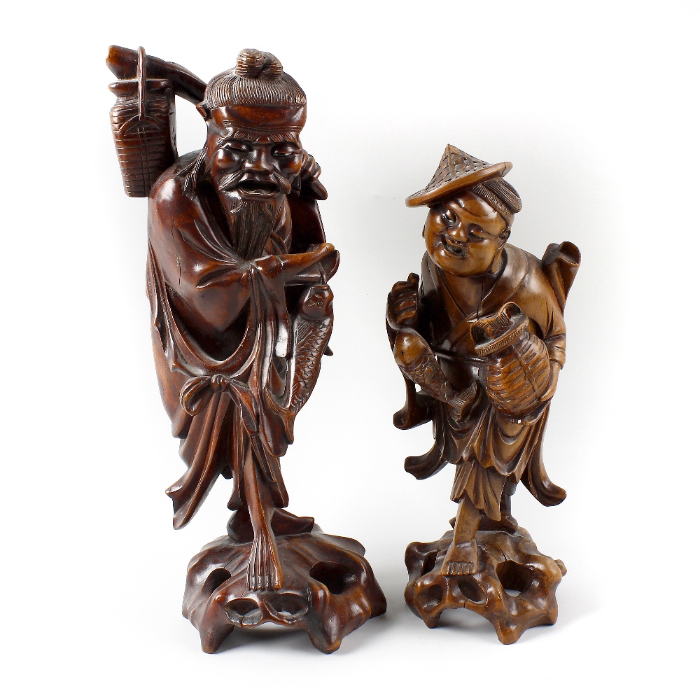 Two Japanese rootwood figures Each modelled as a fisherman with creel and fish, 14 and 11.5 high