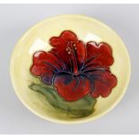 A small Walter Moorcroft dish. Of shallow form having central orchid flower upon a merging pale