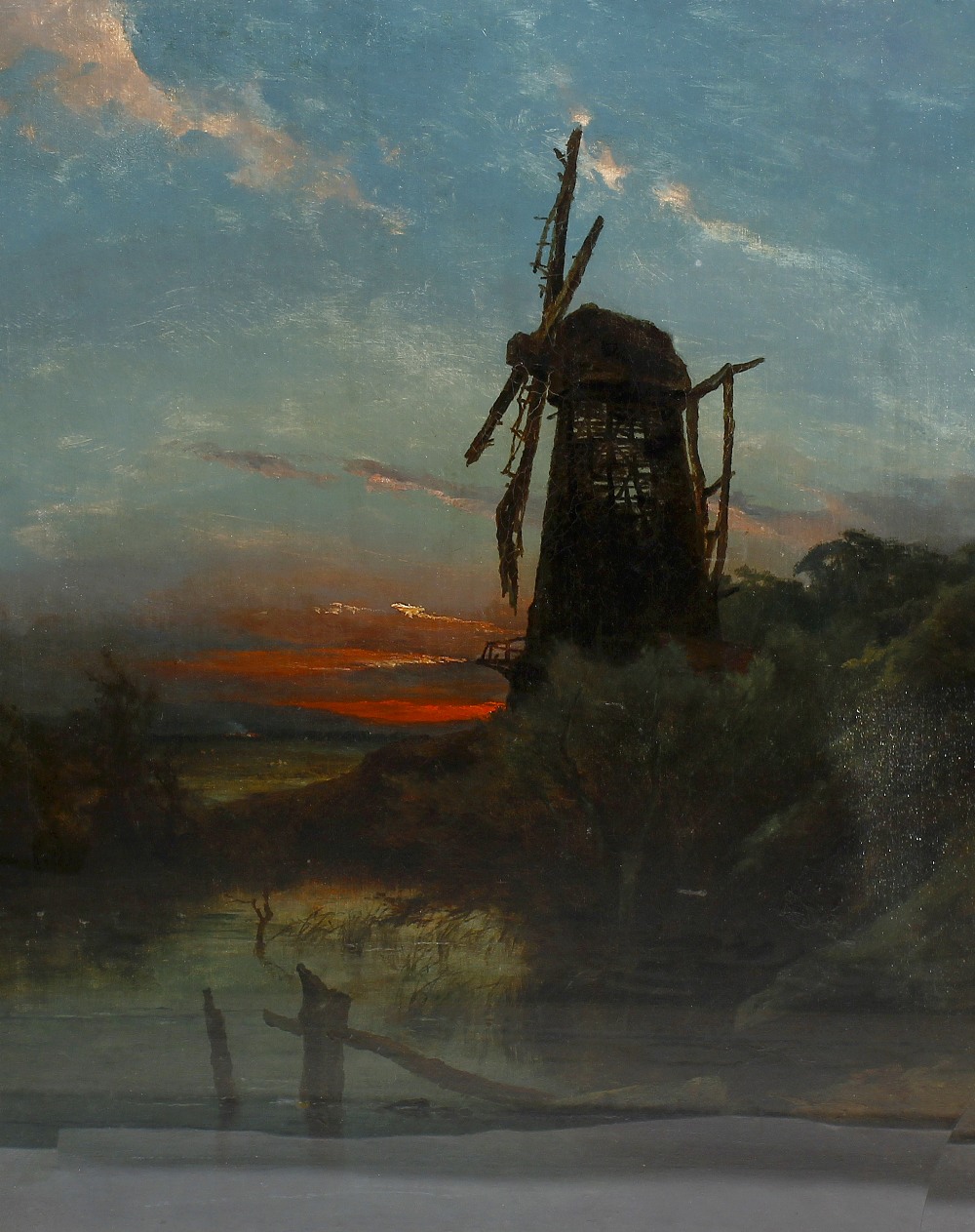 Ex Tommy Tranter Collection: A late 19th century oil on canvas Rural landscape with a windmill at