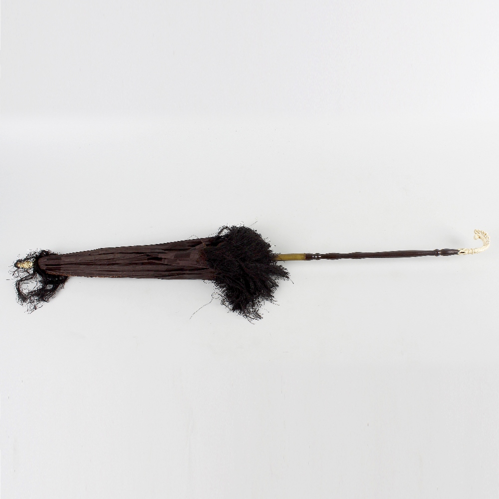 A Victorian bone-handled parasol. With turned handle and terminal, the black silk fabric with