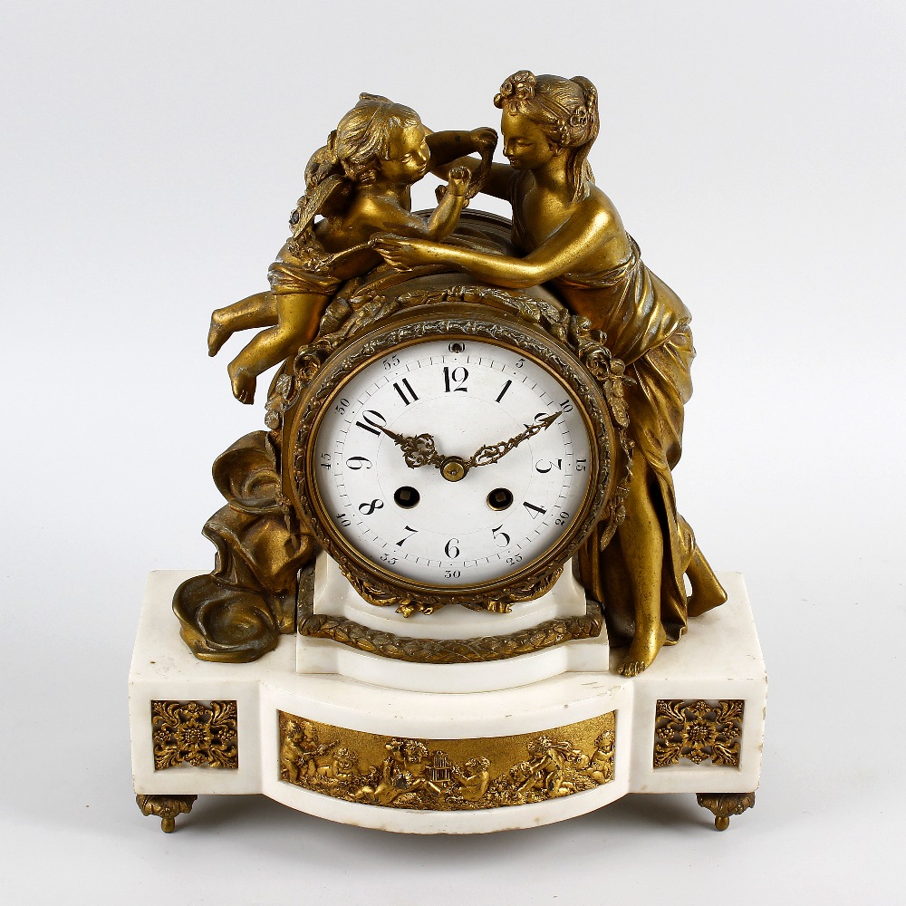 An early to mid 19th century French ormolu and white marble mantel clock.Samuel Marti, Paris.