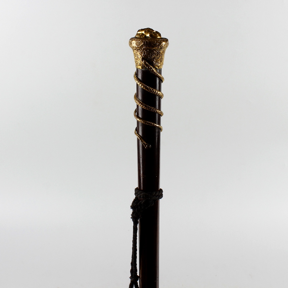 A 19th century gilt metal-topped treen walking stick or cane. The mushroom top with a relief mask