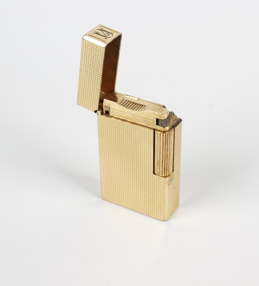 A Dupont gold-plated cigarette lighter. 558CFJ, of textured rectangular form, 2.25, (5.5cm) high. - Image 2 of 2