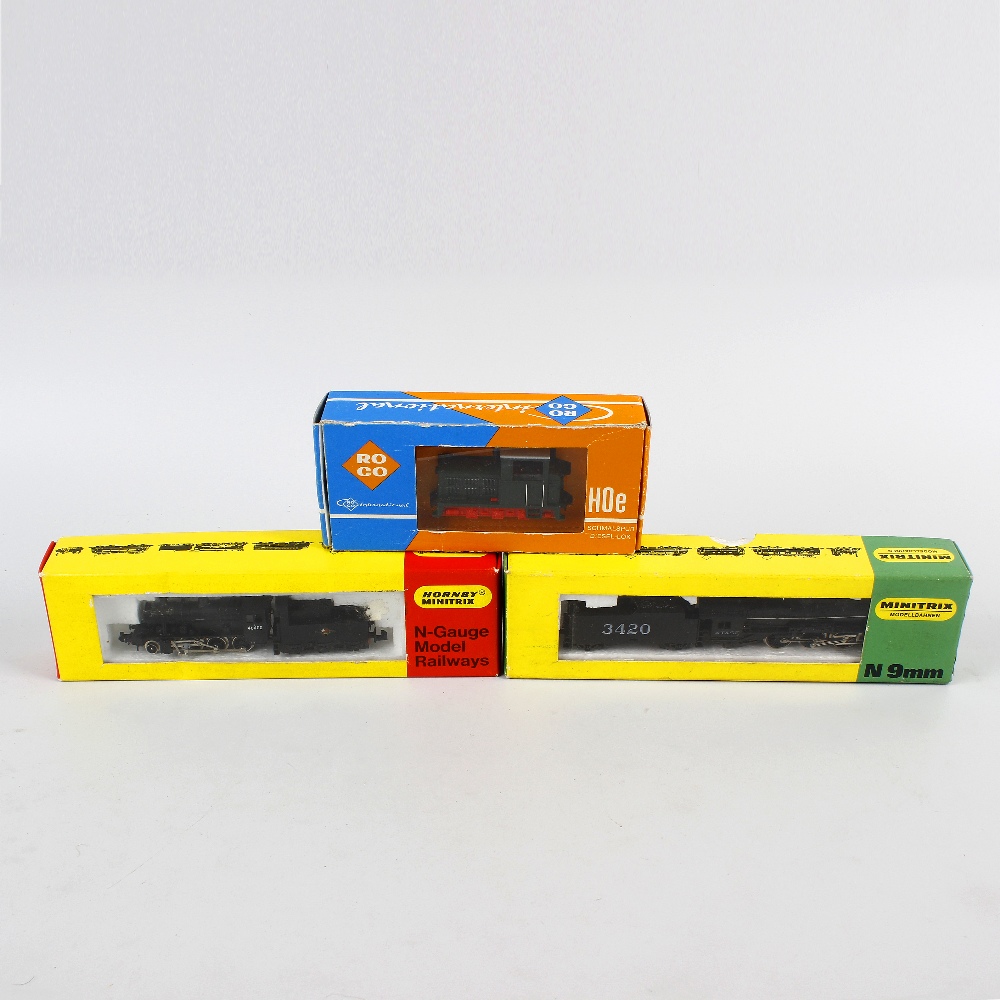 A box containing two Hornby Minitrix N gauge model railway locomotives, an unboxed N gauge model