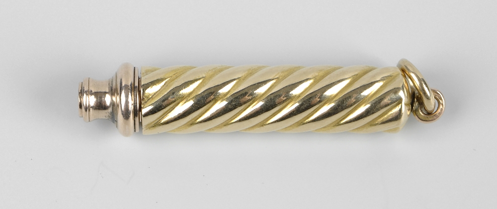 A yellow metal propelling pencil, unmarked, outer sleeve tests as 9ct, with spirally-reeded body