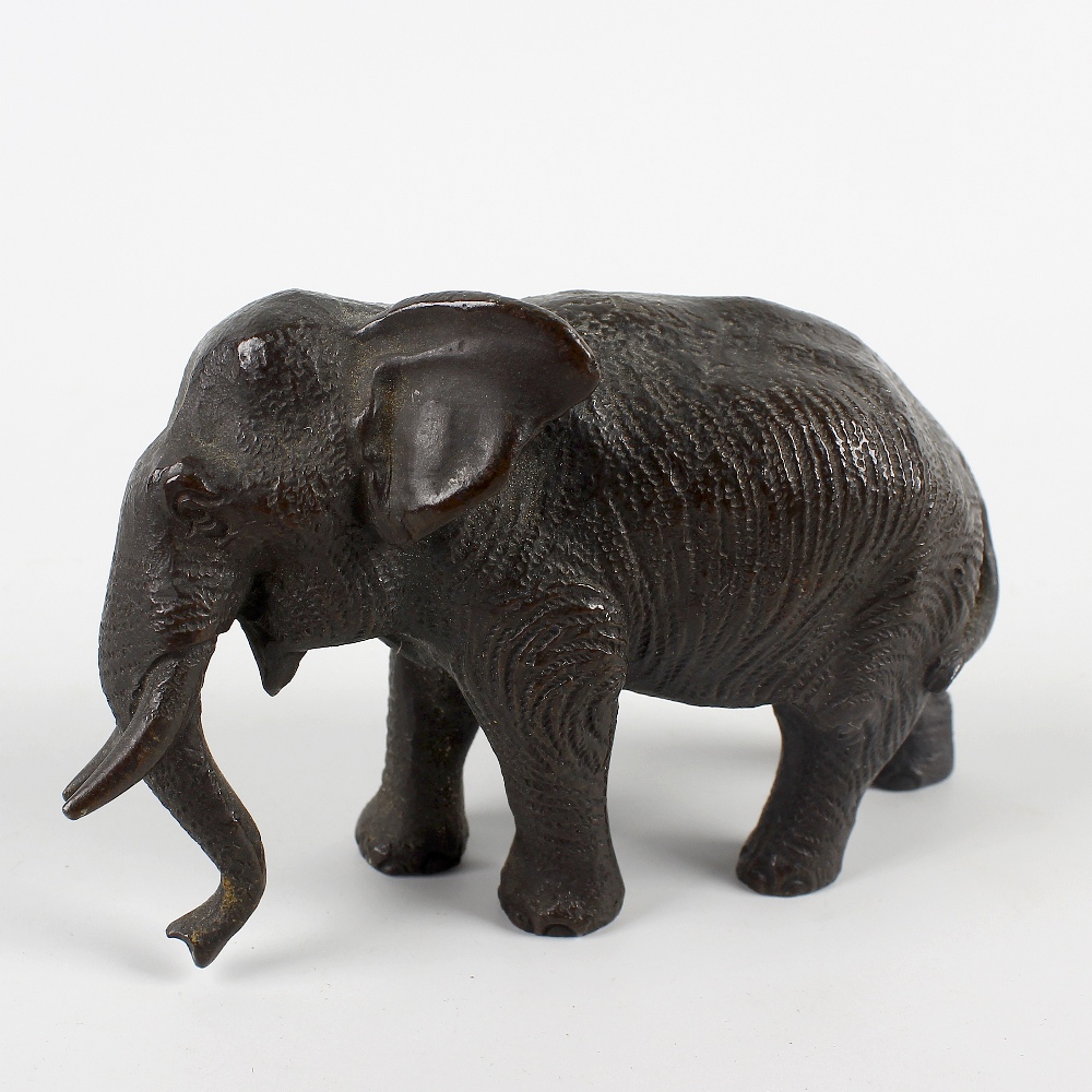 A small cast bronze figure of an elephant. Probably Japanese, Meiji period, modelled in walking