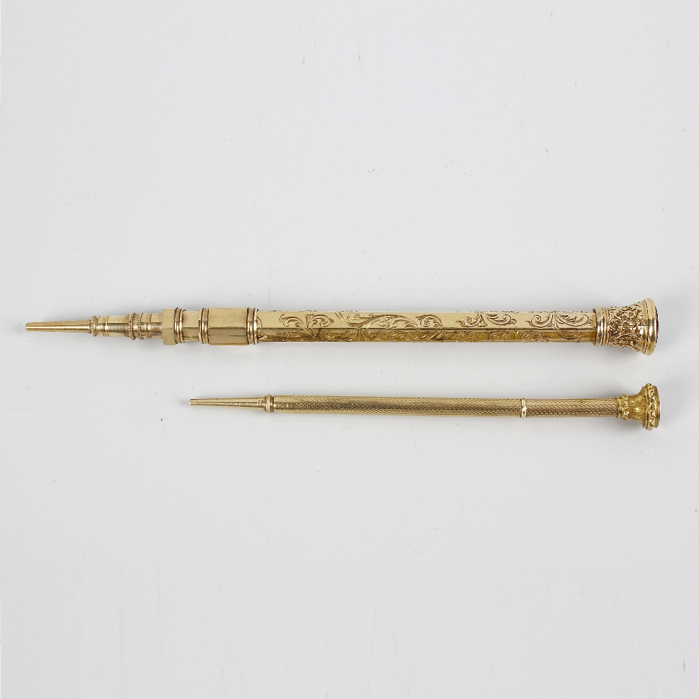 A yellow metal retractable pencil, the hexagonal barrel having foliate engraved decoration and