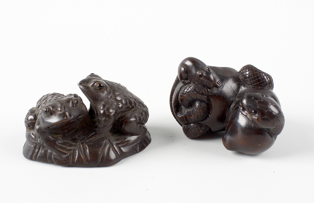 Two Japanese hardwood netsuke. The first modelled with two toads on a lily pad, 1.75, (4.75 cm)