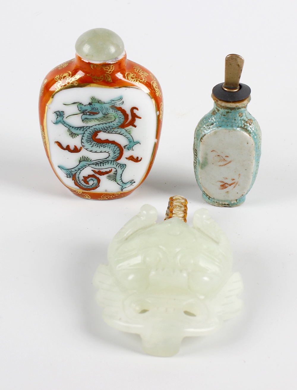 A pair of dyed Jade scroll weights, a carved jade buckle modelled as the face of a demon 2.25 5.